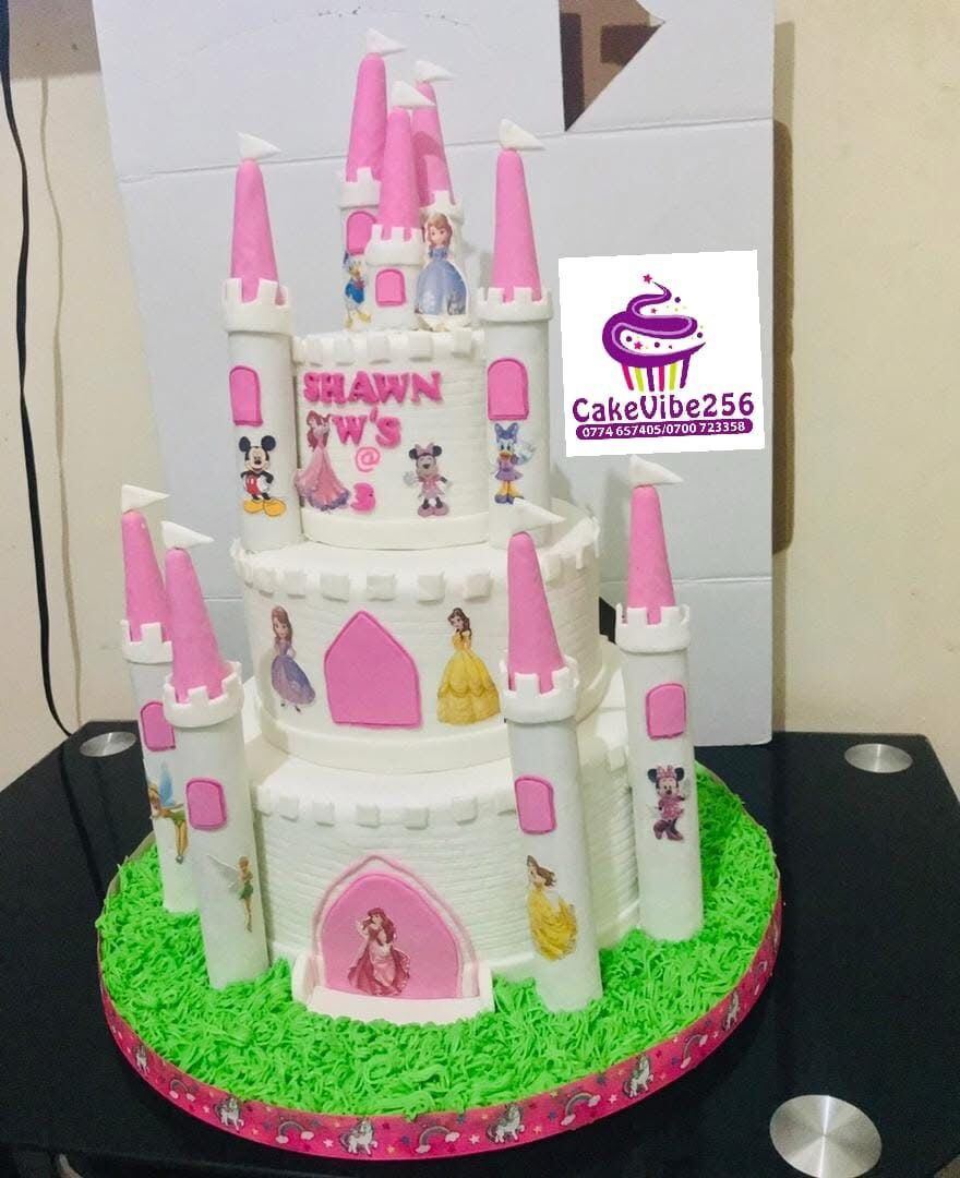 Princess castle birthday cake with Disney character cutouts