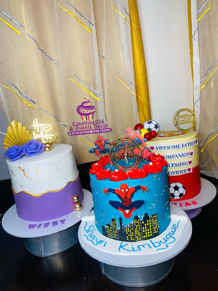 Purple and gold birthday cake alongside Spider-Man and football themed cakes
