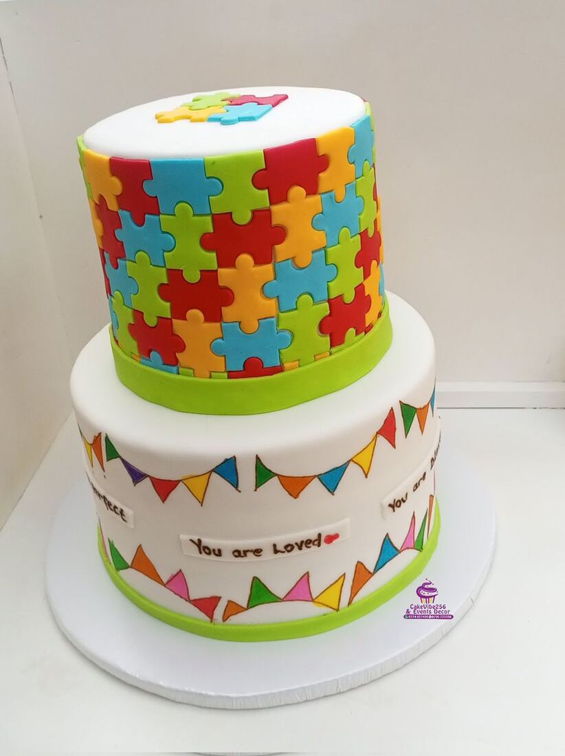 Puzzle piece themed cake with You Are Loved message