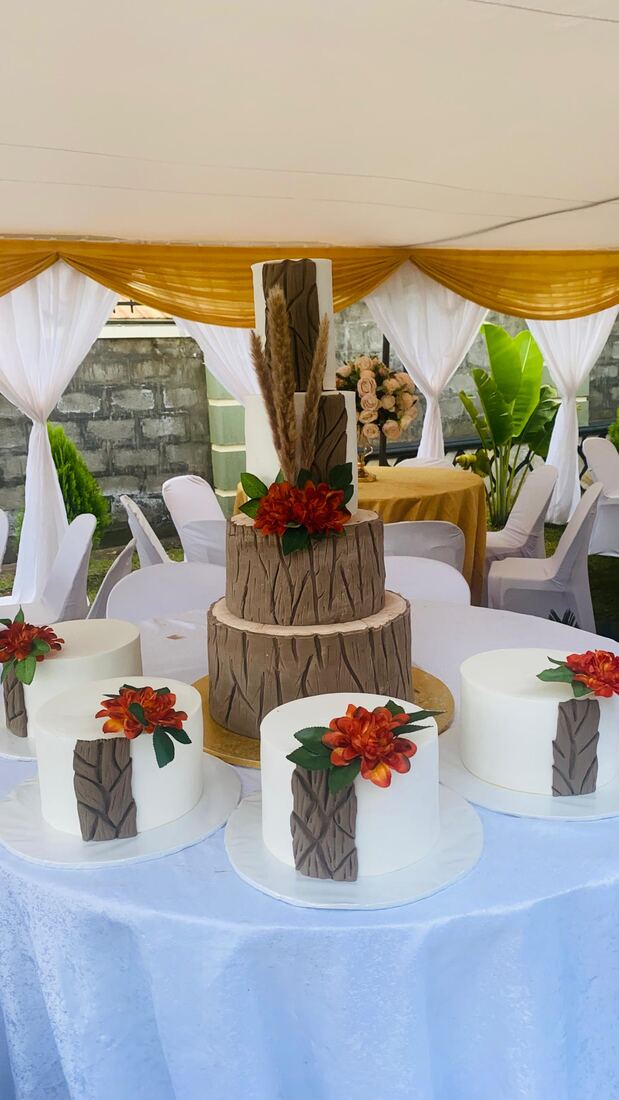 Rustic wood-effect wedding cake with dried flowers, Kampala