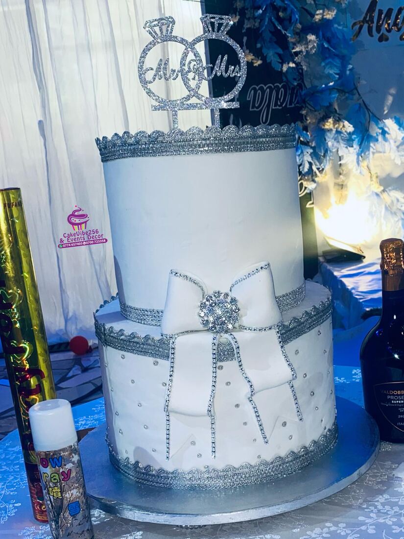 White and silver diamante wedding cake with Mr and Mrs rings topper